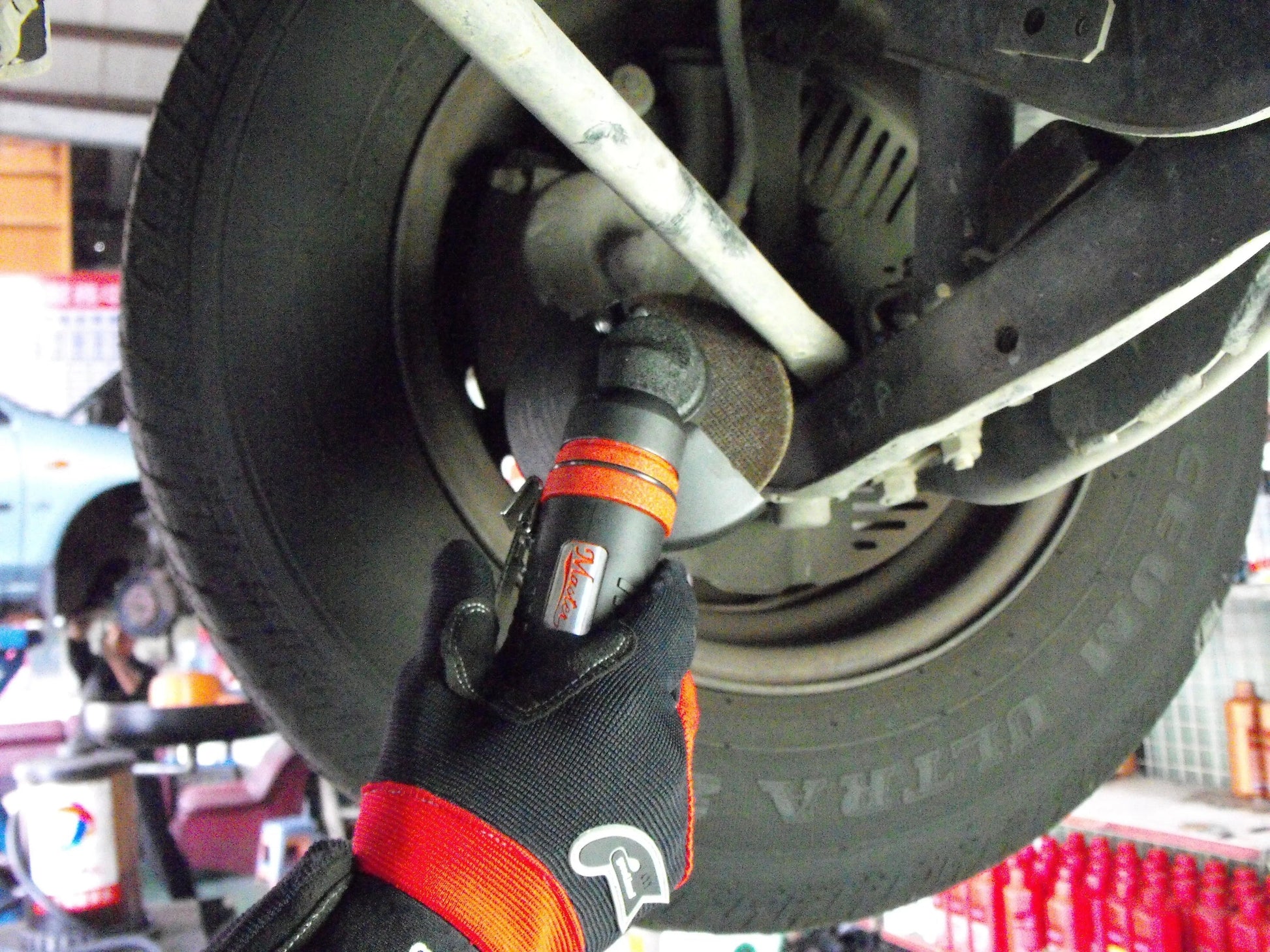 a mechanic working on a tire in a garage