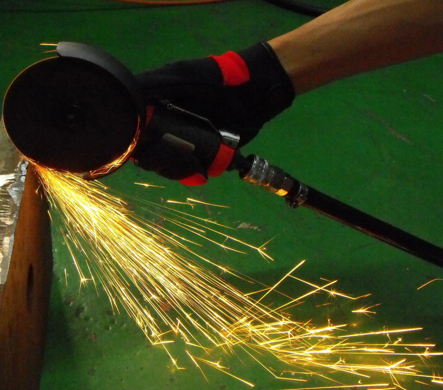 a person using a grinder on a piece of metal