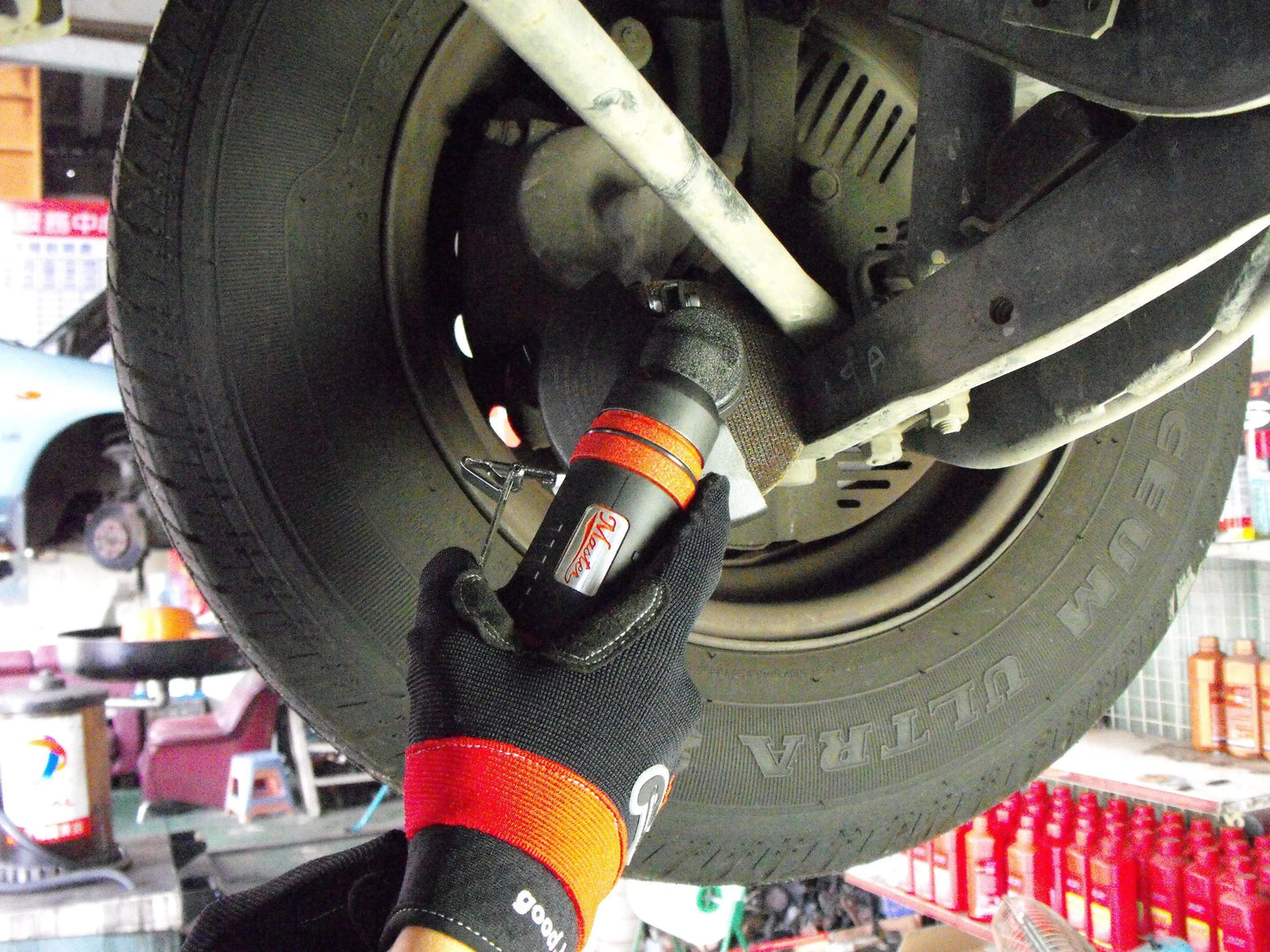 a man working on a tire in a garage